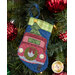The completed Truck stocking, hung on a green Christmas tree decorated with red bulbs.