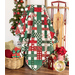 The picnic quilt, artfully draped over a ladder to show dimension and form. The quilt is surrounded by coordinating Christmas decor.