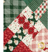 An angled close up on the criss cross design of the picnic quilt in red, green and cream, showing fabric and stitching details. Stitched holly leaves can be seen across the fabric.