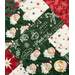 A super close up on the criss cross design of the picnic quilt in red, green and cream, showing fabric and stitching details. Stitched holly leaves can be seen across the fabric.