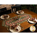 The completed table runner staged on a brown table with four plates set with silverware and coordinating Up On the Housetop napkins.