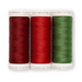 Image featuring three spools of thread in red, green, and dark red isolated on a white background.