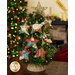 The completed Star of Wonder Nativity ornaments staged on a small Christmas tree; in the background a fireplace and large Christmas tree are blurred. A yellow banner in the upper right hand corner reads 