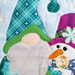 A super close up on the applique gnome and snowman, showing fabric and topstitching details.