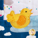 A super close up on the applique yellow ducky, showing fabric and topstitching details.