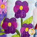 A super close up on the applique pansies, showing fabric and topstitching details.