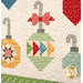 A super close up on a three patchwork ornaments, demonstrating fabrics, piecing, and top quilting details.