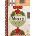 A close up on a quilt featuring a holiday-themed design with a large green ornament that has the word Merry in the center, surrounded by red berries and leaves. The quilt is bordered with various patterned fabric strips.