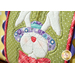 A super close up on the center applique rabbit of the pillow, demonstrating fabric and stitching details on the hat and bowtie.