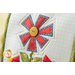 A super close up on the center applique flower of the pillow, demonstrating fabric and stitching details.