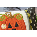A super close up on the center applique jack o'lantern of the pillow, demonstrating fabric and stitching details.