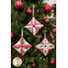 The three completed ornaments, hung on a decorated and lit tree.