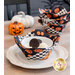 A decorative fabric bowl with ice cream and cookies, set against a backdrop of coordinating decor like pumpkins and three other bowl cozies.