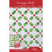 Front of the Scrappy Holly pattern showing the completed project quilt with a Holly motif with white background fabric.