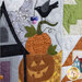 An angled shot of the stack of pumpkins, demonstrating fabric details, colorful buttons, and top quilting details.