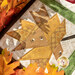 A close up shot of a yellow maple leaf, surrounded by colorful oak leaves with artful shadows and lighting cast across the project.