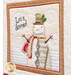 A super close up on one of the panel blocks, showing top quilting details on a happy snowman beside the text 