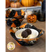 A decorative fabric bowl of vanilla ice cream and cookies, surrounded by coordinating decor and other bowl cozies