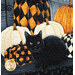 A close up of a cat and pumpkins in the panel, demonstrating fabric and top quilting details.