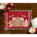 A top-down image of the Home Sweet Home panel placemat on a wooden table, with fabric napkins, peppermint candy, and a mug of hot cocoa peeking into the corners of the frame.