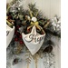 A holiday wreath featuring floral decorations, red berries, and a white angel ornament with Hope.