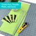 A cutting mat with a rotary cutter, fabric pieces, and a ruler, with text about creating quilt patterns.