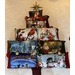 A decorative arrangement of Christmas-themed pillows shaped like a tree, topped with a star.