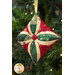 One of the three completed cathedral ornaments, in green, cream, and red, staged on a Christmas tree.