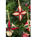 A shot at a slight angle of the three completed cathedral ornaments in cream, red, and green, staged on a decorated and lit Christmas tree.