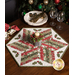 A shot of the table topper holding a festive candle with holly, surrounded by coordinating napkins and decor.