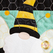 A super close up on the applique bee gnome, demonstrating fabric and topstitching details.