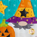 A super close up on the applique witch gnome, demonstrating fabric and topstitching details.