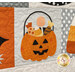 A super close up on the jack o'lantern trick or treat bucket block, showing fabric, applique, and top quilting details.