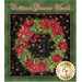 An ornate green patchwork wreath embellished with red poinsettias on a black background.