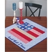Square 'Land That I Love' table topper featuring a patchwork American flag.