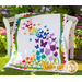 The beautiful Blooming Butterflies quilt draped over a chair outside | Shabby Fabrics