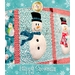 A close-up image of a snowman in a blue scarf.