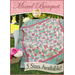 Turquoise and pink patchwork quilt from squares and half-square triangles. 