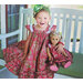An image of a little girl and her doll wearing the Swing Dress & Dolly Swing Dress.