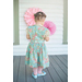 An image of a little girl wearing the Elizabeth and Eden Ensemble from behind showing the buttons up the back.