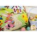 Close-up of applique bunny in a sun hat and poodle skirt with a basket of eggs.
