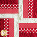 The first red and white block in the Learn to Quilt Beginner Quilt