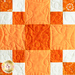 The second orange and white block in the Learn to Quilt Beginner Quilt