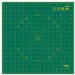 Green Olfa rotary cutting mat with a grid and a 12-inch ruler marked along the bottom edge