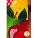 Close-up of green and red applique apples with glitter detailing.