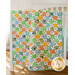 Orange, yellow, green, and blue flannel patchwork quilt with fruit and veggie print.