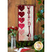 The beautiful February A Year In Words Wall Hanging laid flat on a wood table