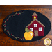 Black oval mug mat with a yellow apple and red school house stitched down | Shabby Fabrics