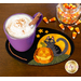 Halloween themed mug mat with a cup of cocoa resting on top