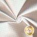 Light reflecting off scrunched up tonal white houndstooth fabric
